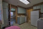 Kitchen is equipped with an electric range, drip coffee pot, toaster, microwave and full size fridge.